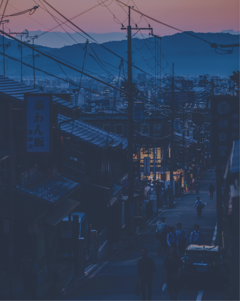 City street at dusk with mountains in the background